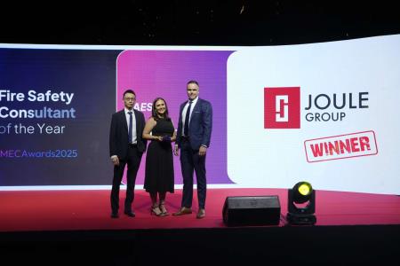 Joule Group employees standing proudly on stage holding the Fire Safety Consultant of the Year award ceremony